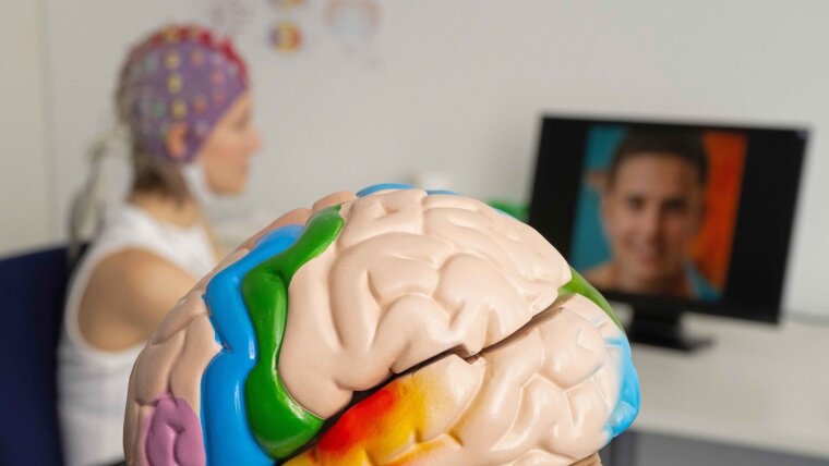 To demonstrate the experimental setup, Charlotta Eick wears a cap fitted with electrodes.