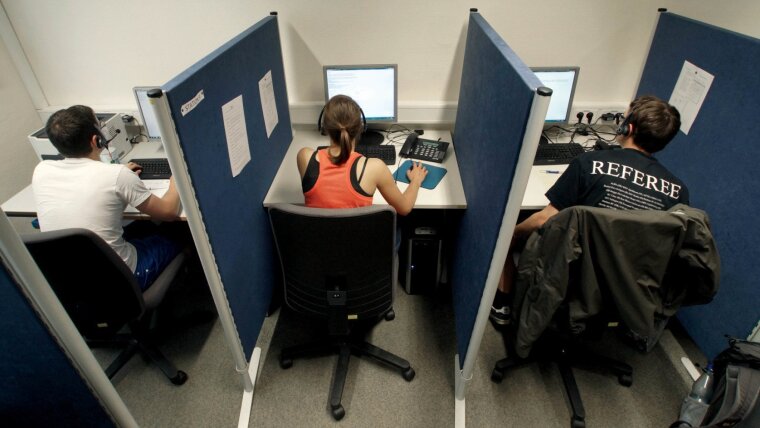 Students at the CATI laboratory interview study participants on the phone.