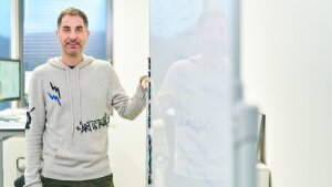 Gianni Panagiotou, Professor of Microbiome Dynamics, standing next to a whiteboard.